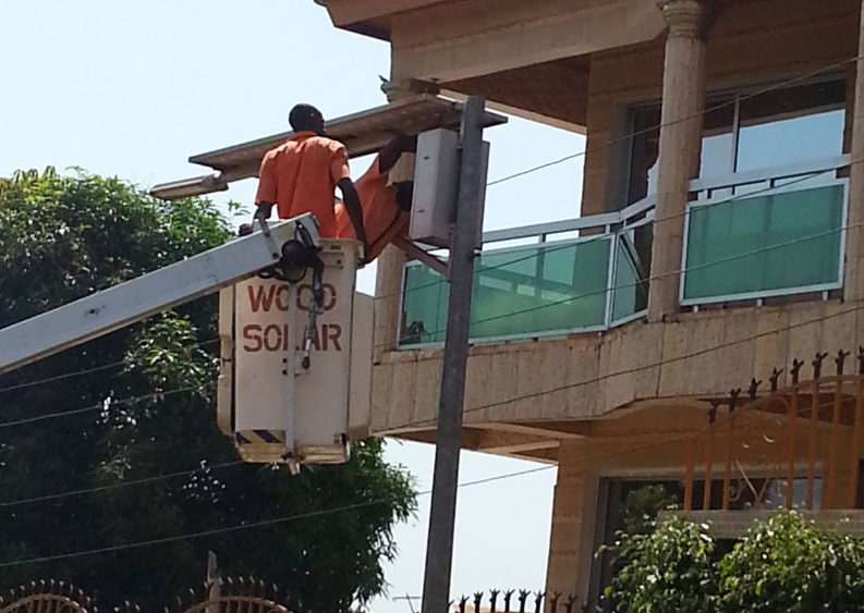 Woco Solar technician performing electrical installation work